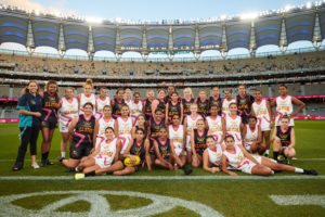 deadly sista girlz girls football team in uniform standing on the ground at optus stadium